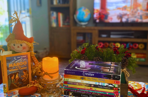 A stack of children's books sit on a fall-themed coffee table.