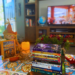 A stack of children's books sit on a fall-themed coffee table.